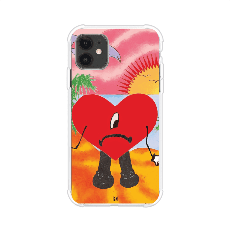 Funda para iPhone inspirada en el álbum "Un Verano Sin Ti" de Bad Bunny. Diseño con fondo de playa, palmeras, atardecer, delfines y el icónico corazón triste con piernas. Estilo colorido, urbano y veraniego. Producto de Remark Mx