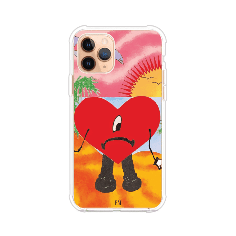 Funda para iPhone inspirada en el álbum "Un Verano Sin Ti" de Bad Bunny. Diseño con fondo de playa, palmeras, atardecer, delfines y el icónico corazón triste con piernas. Estilo colorido, urbano y veraniego. Producto de Remark Mx