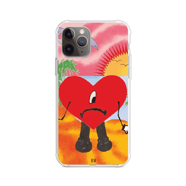 Funda para iPhone inspirada en el álbum "Un Verano Sin Ti" de Bad Bunny. Diseño con fondo de playa, palmeras, atardecer, delfines y el icónico corazón triste con piernas. Estilo colorido, urbano y veraniego. Producto de Remark Mx