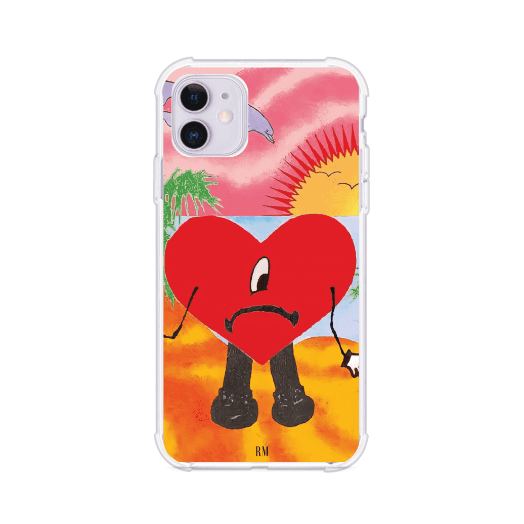 Funda para iPhone inspirada en el álbum "Un Verano Sin Ti" de Bad Bunny. Diseño con fondo de playa, palmeras, atardecer, delfines y el icónico corazón triste con piernas. Estilo colorido, urbano y veraniego. Producto de Remark Mx